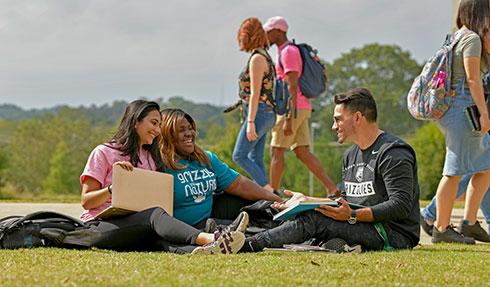 Engaged student studying on the GGC Lawn