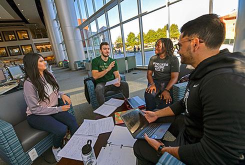 Engaged students near library windows