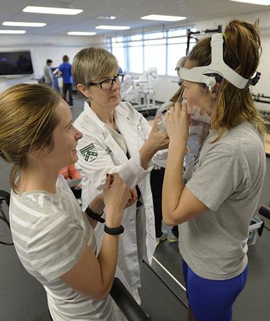 Exercise science faculty instructing students in performance testing