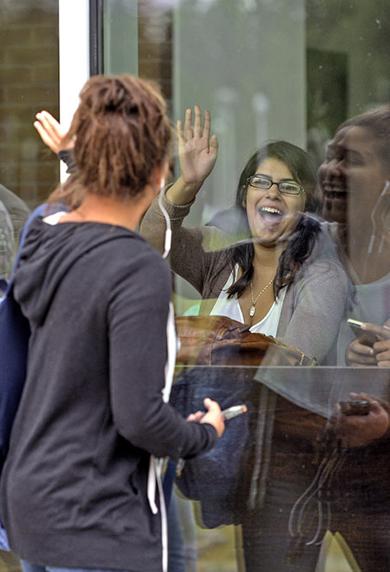 Students waving hello