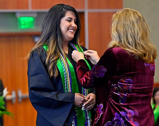 Camila Monteiro at Nursing Pinning Ceremony with Dean Diane White, School of Health Sciences