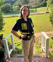 Georgie Hardy standing on stairs wearing a GBI vest