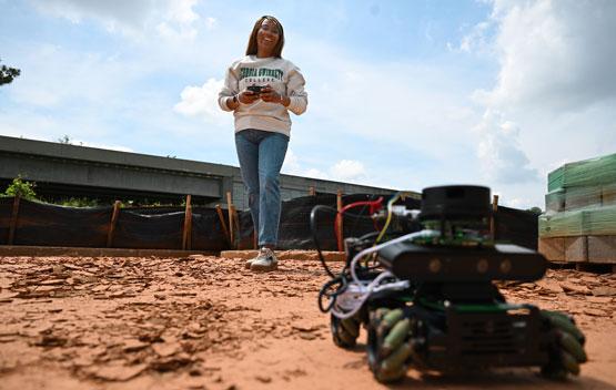 Tamera Crawford drives one of the Dynamic Objective-Reaching Autonomous Rovers (DORA)