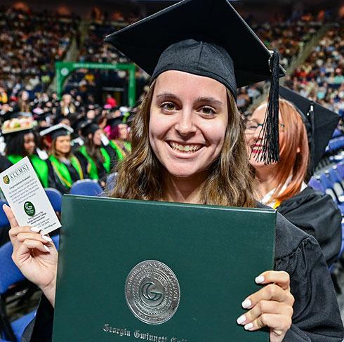 Female graduate with diploma at commencement