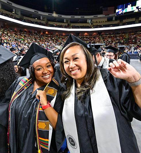 Female graduates posing at commencement