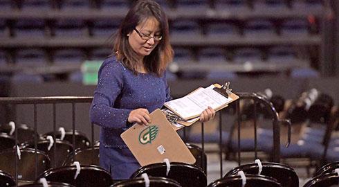 Staff member preparing for commencement ceremony