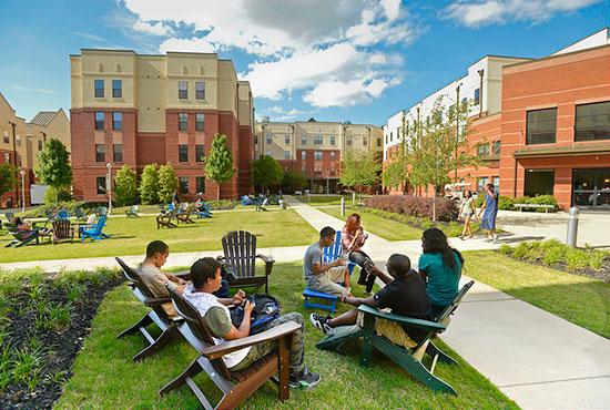 Grizzly residents socializing in Adirondack chairs in housing courtyard