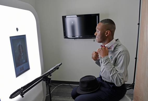 Male student fixing his bowtie for a professional photo