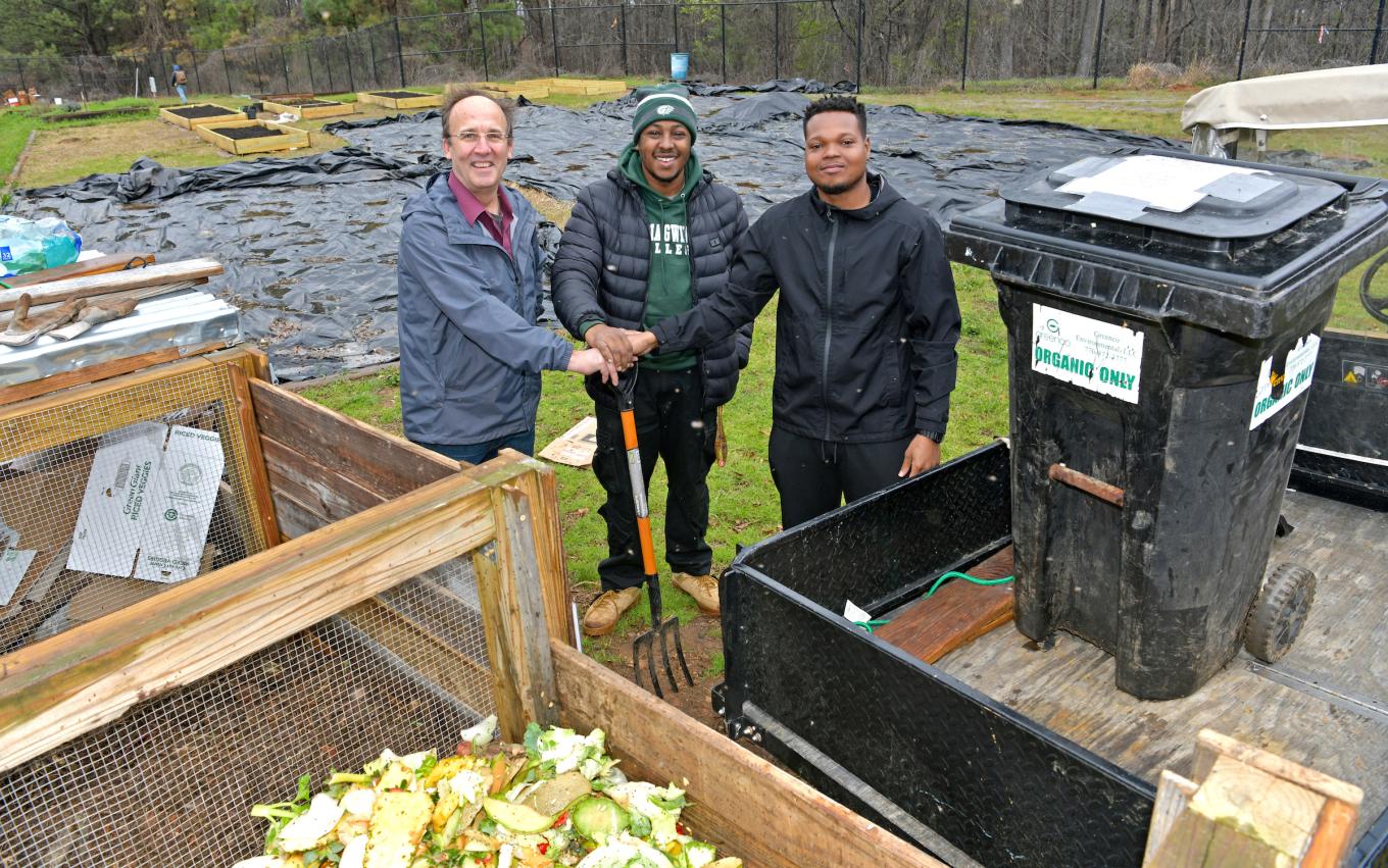 Dr. James Russell and students K.J. Hartfield and Stephen Johnson work together to turn dining hall waste into compost.