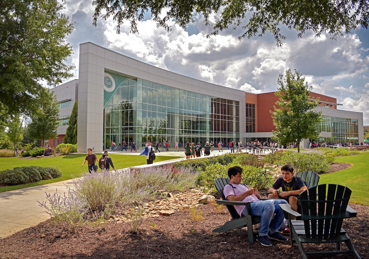 GGC Kaufman Library and Learning Center, students walking and students studying in Adirondack chairs