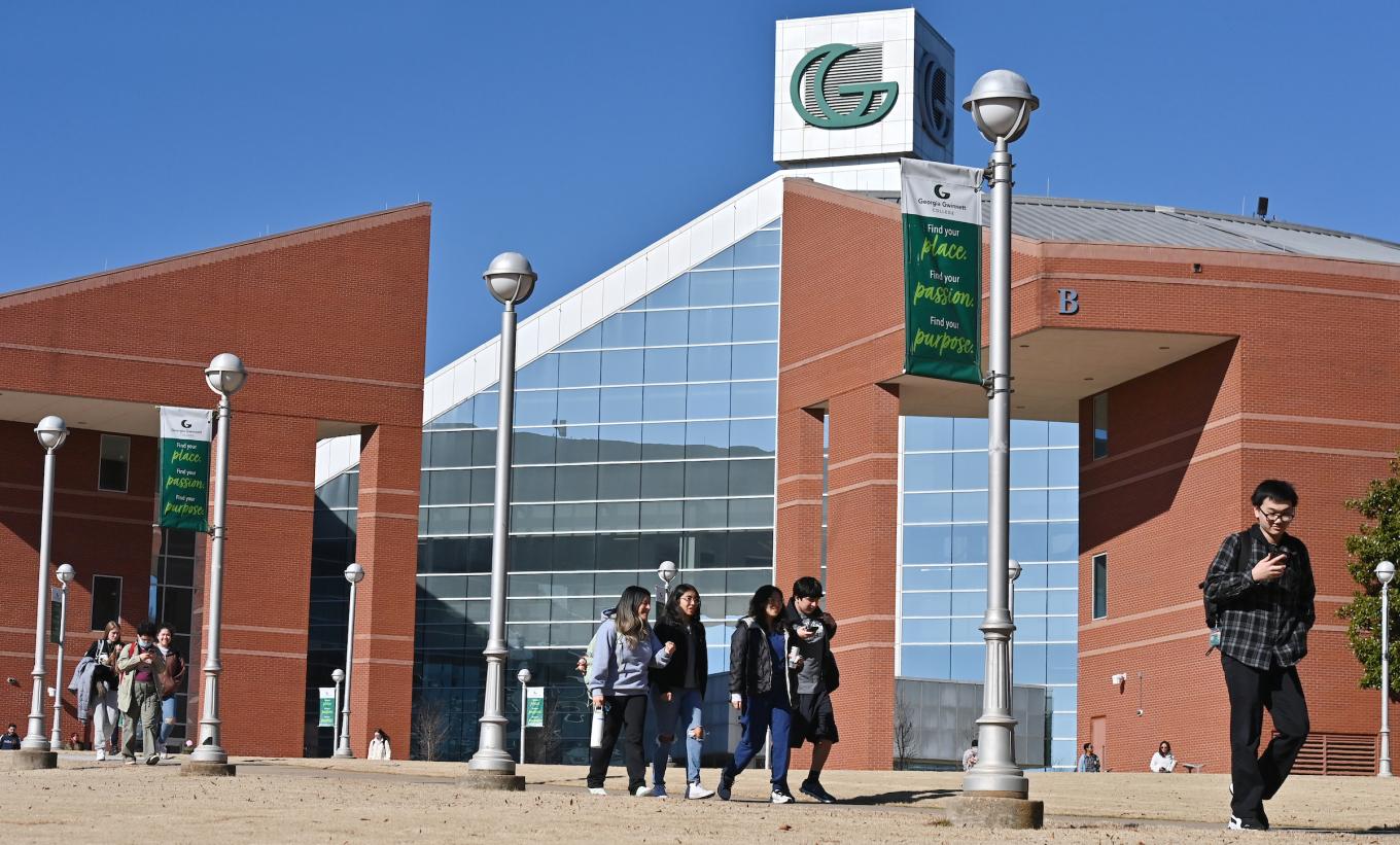 Students walking in front of Building B on campus.