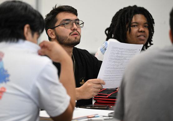 Tony Montenegro follows along as Dr. James Price works through a calculus equation in Math 2200