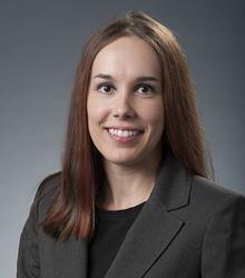Dr. Reanna Berry wearing gray jacket and black shirt smiling at camera