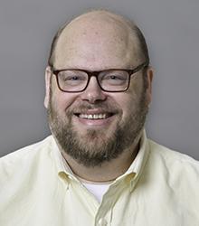 Dr. Eugene Berger smiling at camera