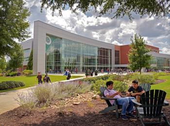 GGC Kaufman Library and Learning Center, students walking and students studying in Adirondack chairs