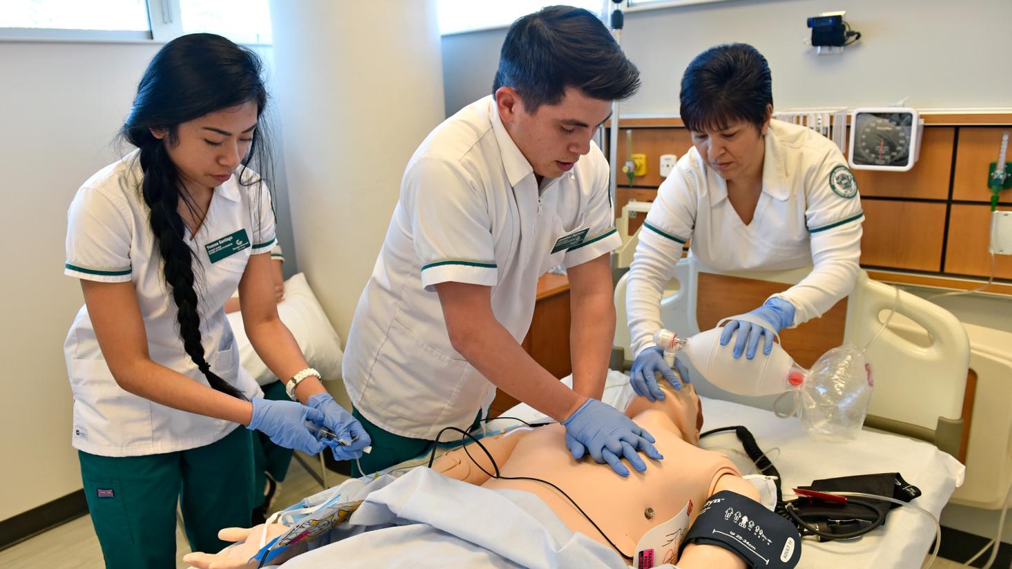 Nursing student performing CPR on a mannequin