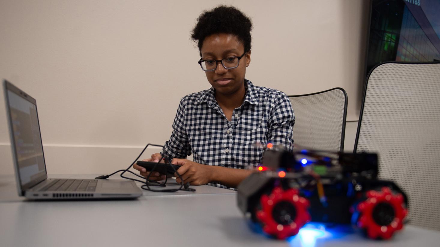 Female student works with small remote-controlled car