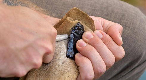 GGC student demonstrating flint knapping