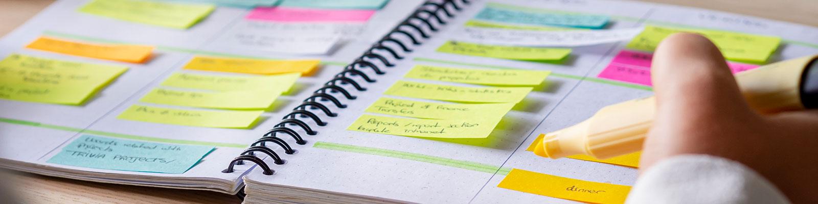 hand highlighting dates in planner hand highlighting dates in planner