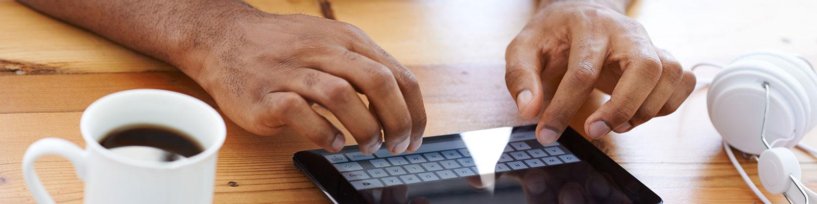 hands typing on tablet keyboard hands typing on tablet keyboard